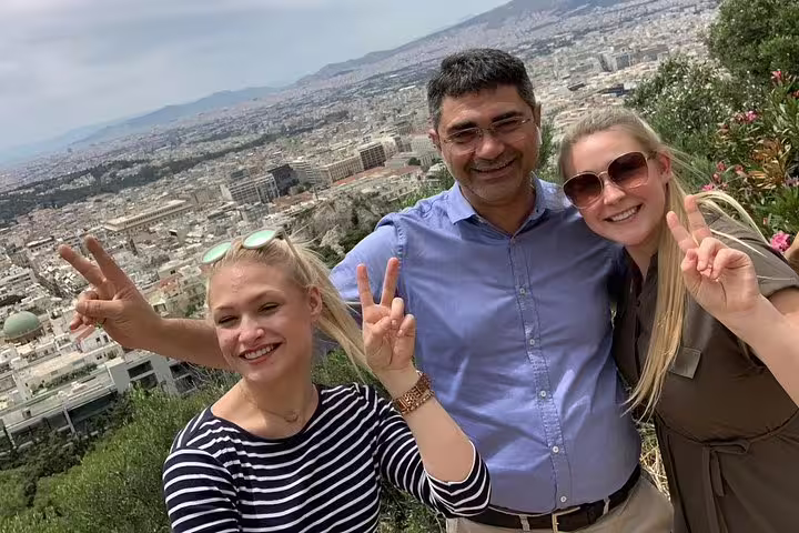 Happy travelers with guide at Lycabettus Hill viewpoint on private half-day Athens city tour