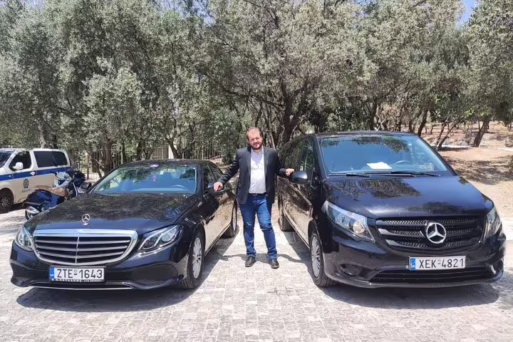 Private Athens tour driver beside Mercedes sedan and van, offering VIP half day sightseeing transfers