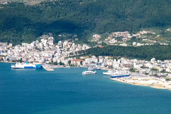 Igoumenitsa port waterfront with ferries and hillside town, destination view for private transfer from Athens