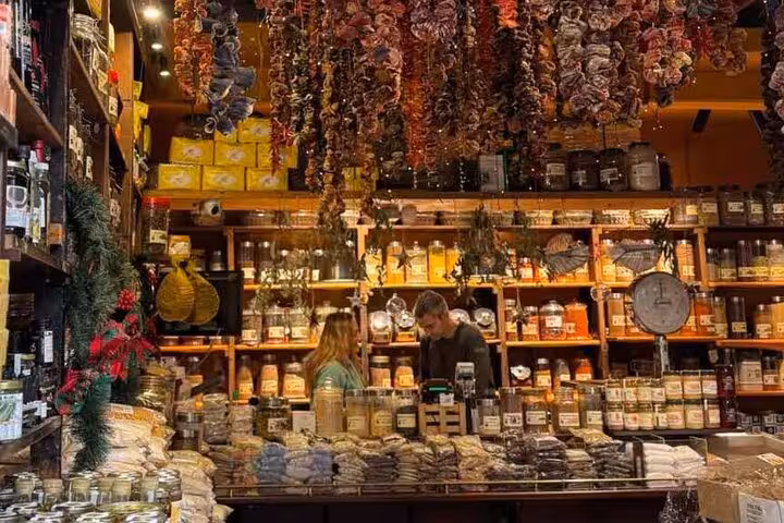 Athens traditional food tour stop at a spice and deli shop with Greek herbs, olives and local delicacies