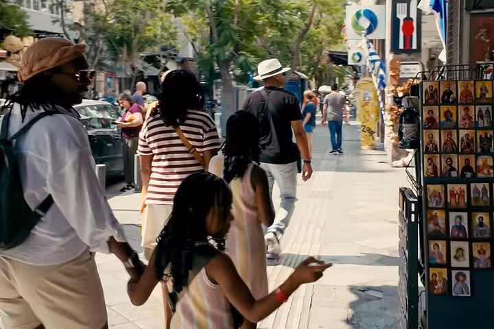 Cruise travelers on a small group Athens walking tour browsing street shops in central Athens, Greece
