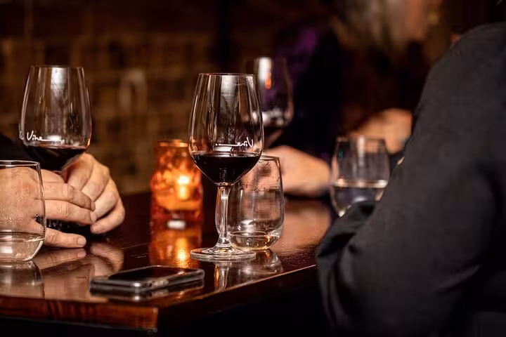 Red wine glasses on a cozy Athens bar table during a private wine tasting with a licensed wine guide
