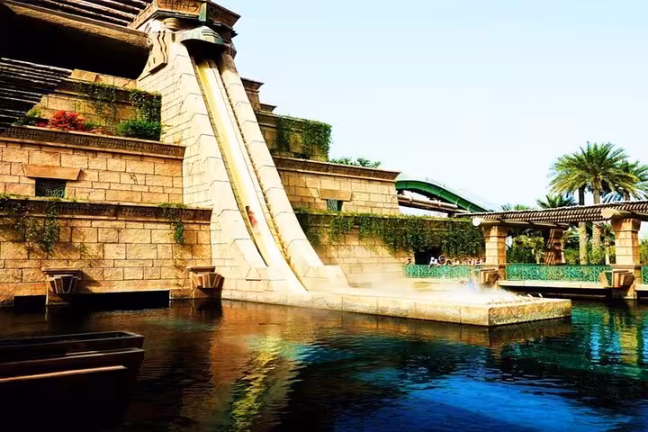 Atlantis Aquaventure Dubai water slide drop into lagoon, iconic temple tower ride with day pass access