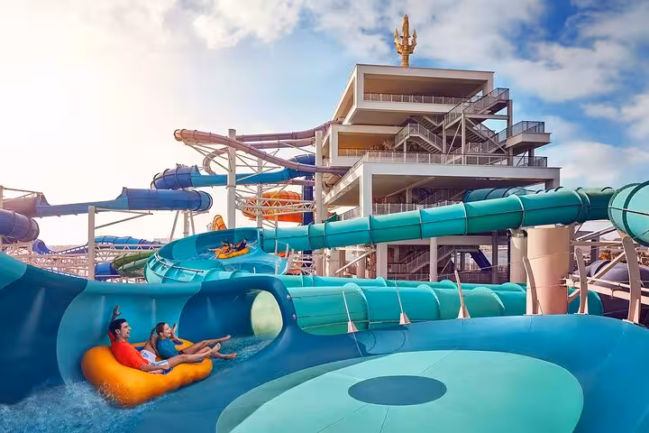 Guests on inflatable raft in Aquaventure Waterpark Dubai slides at Atlantis, included with Super Pass