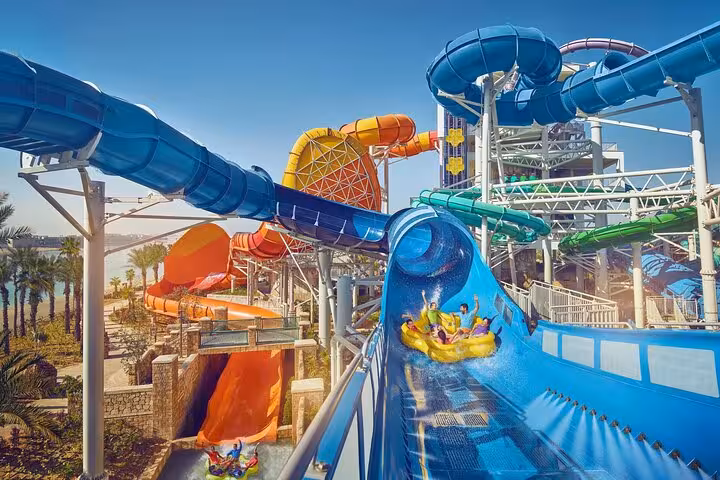 Riders splash through Aquaventure Waterpark Dubai tube slides at Atlantis with Super Pass entry