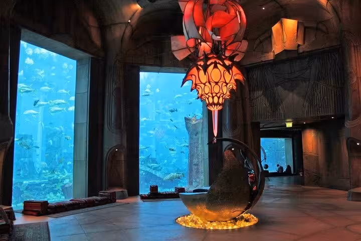 Atlantis The Lost Chambers Aquarium Dubai interior with themed decor, lounge seating and massive viewing panes