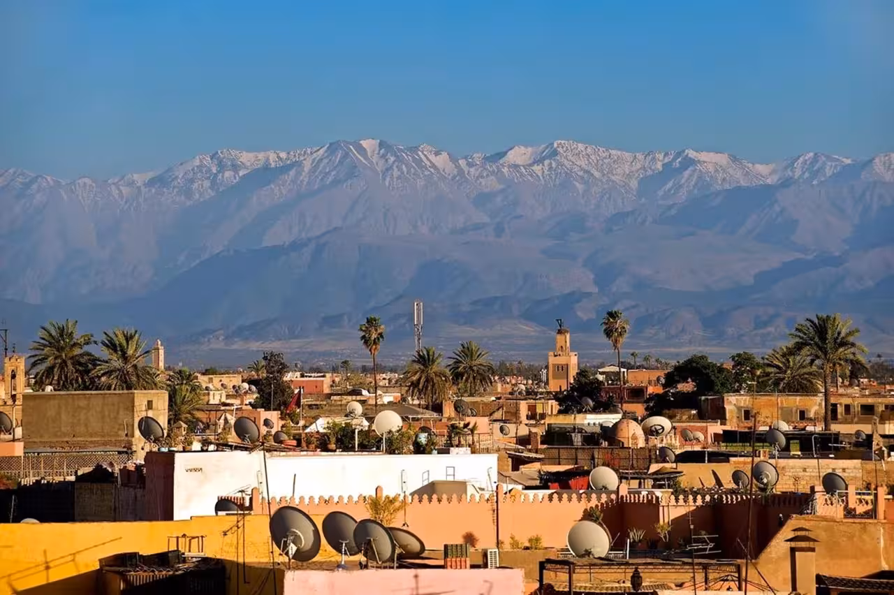 Scenic view of the Atlas Mountains overlooking the vibrant cityscape of Fes, Morocco, on a clear day.
