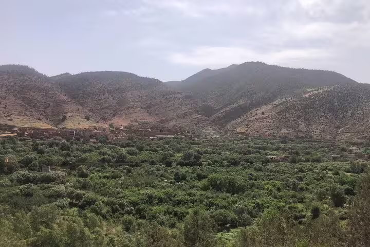 Panoramic Atlas Mountains view over Ourika Valley greenery and Berber villages on a day trip from Marrakech