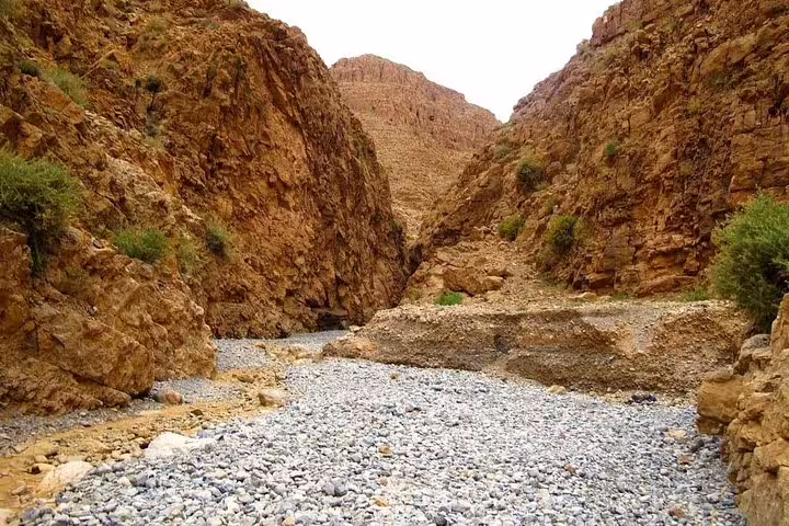 Rocky canyon and dry riverbed in the Atlas Mountains, off-road scenery on 8 day desert tour from Marrakech