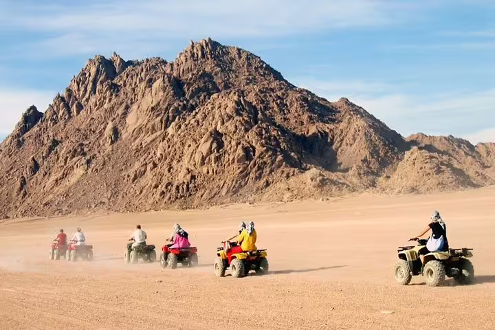 ATV quad bike safari from Sharm El Sheikh crossing Sinai desert plains with rugged mountains ahead