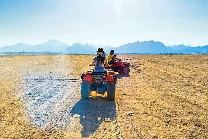 ATV quad biking across Sinai Desert from Sharm El Sheikh on Super Safari tour with mountain views