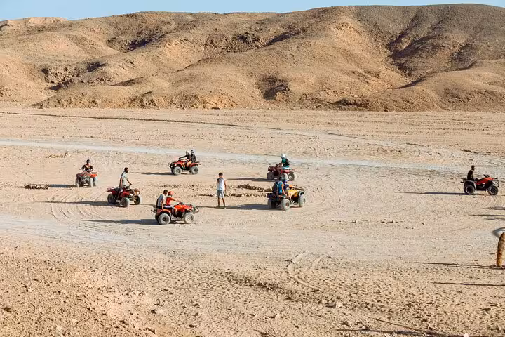 Group ATV quad biking in Sharm El Sheikh desert valley near Echo Mountain, guided off-road safari stop