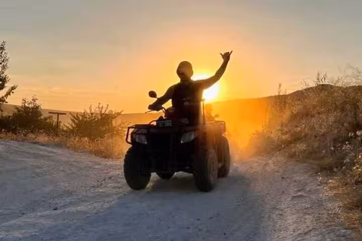 Rider on private ATV quad safari at sunset in Sinai desert, Sharm El Sheikh tour with dinner and stargazing