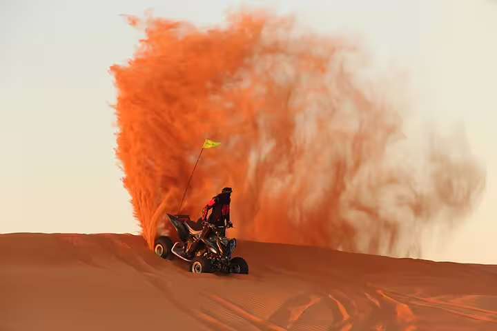ATV rider kicks up sand during thrilling desert safari in Dubai, perfect for adventure seekers with BBQ dinner and live shows.
