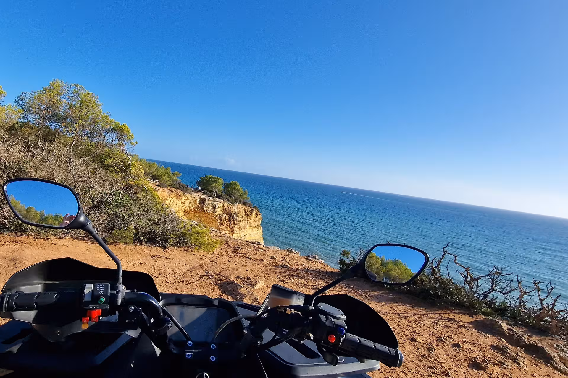 ATV parked at a cliff edge overlooking the ocean, showcasing stunning coastal views in the seven Hanging Valleys.
