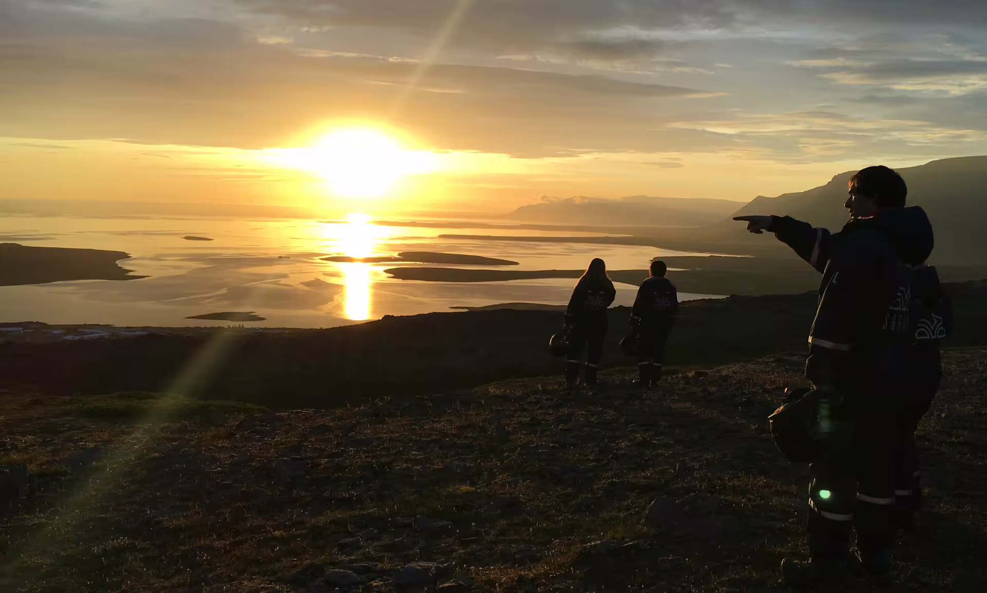 ATV riders enjoy a breathtaking midnight sun over a scenic landscape, perfect for an adventurous 2-hour tour experience.