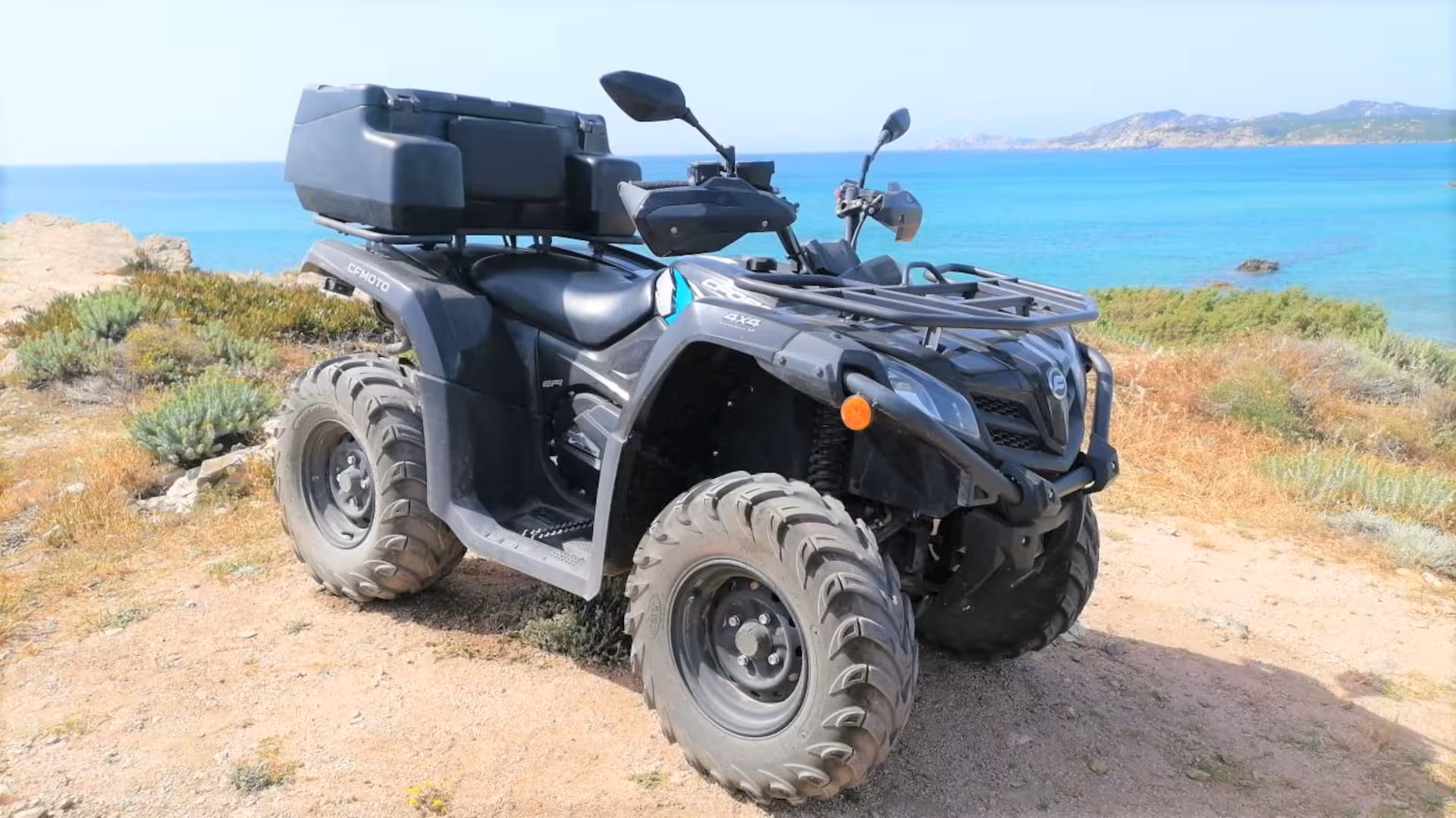 ATV parked on a scenic coastal trail in Santa Teresa di Gallura, offering stunning sea views and adventure.