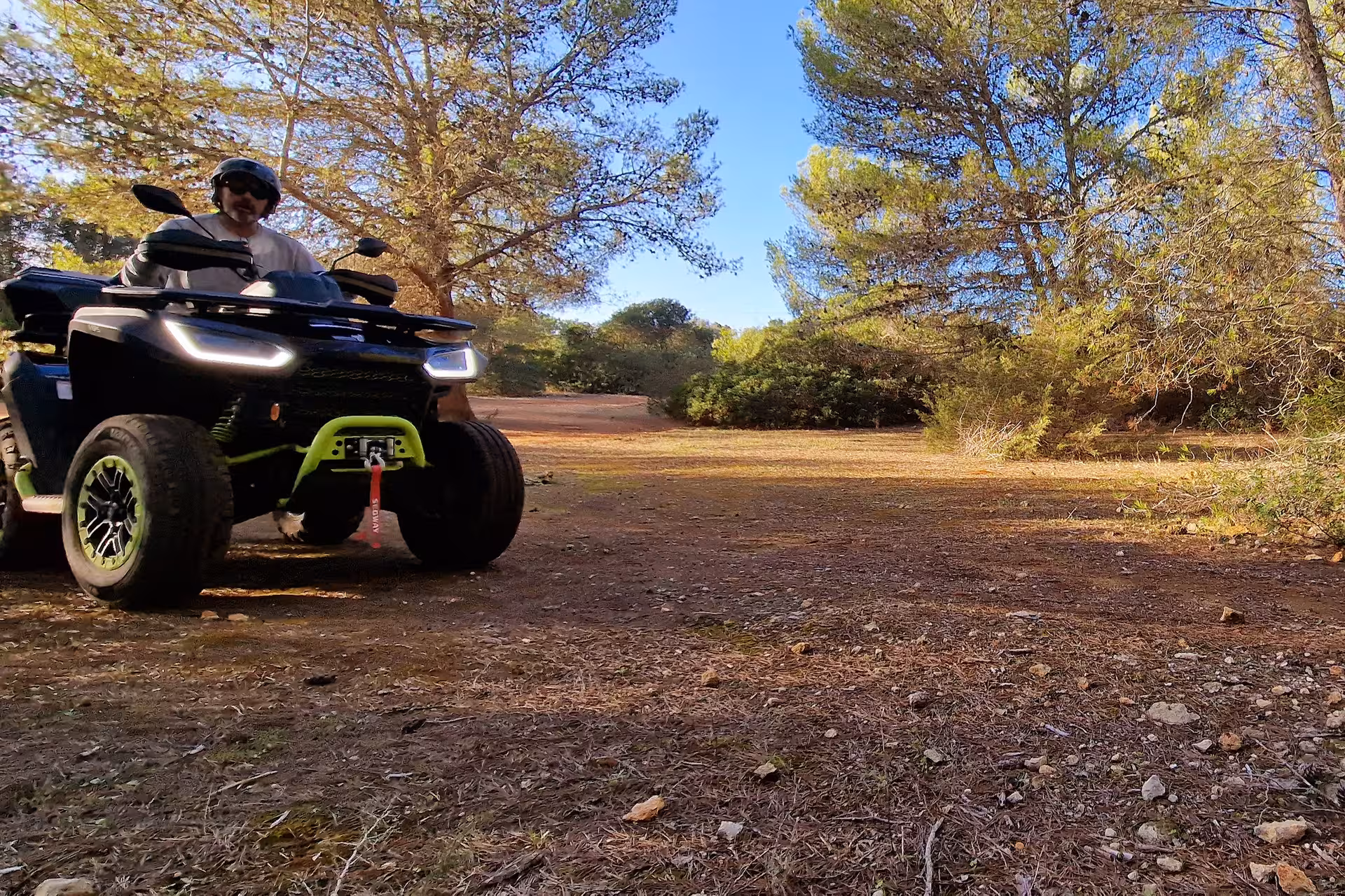 Adventurer on an ATV navigating through a scenic forest trail during a private tour in the seven Hanging Valleys.
