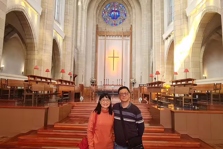 Couple exploring the stunning interior of Auckland's iconic church on a private highlight day tour.