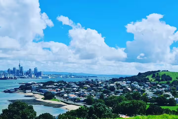 Scenic view of Auckland's skyline and waterfront under a bright blue sky on a city highlights tour.