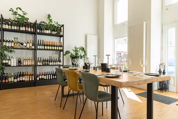 Bright Vienna tasting room set for Austrian wine tasting, with glassware, pairing plates, and bottle shelves