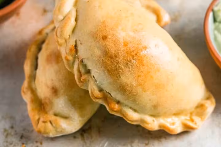 Golden-brown empanadas filled with savory delights, showcasing authentic flavors on Medellín’s Laureles food tour.