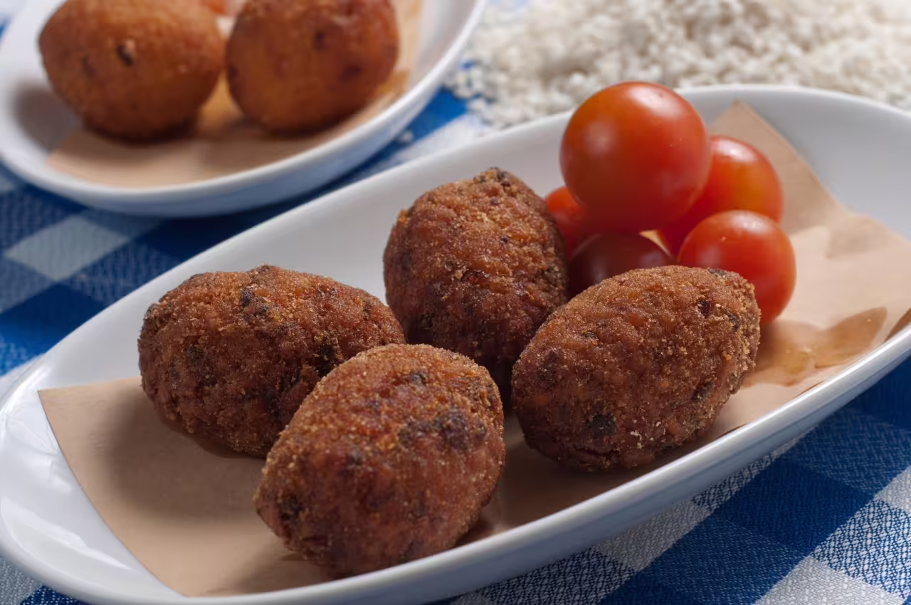 Savor authentic Italian arancini with cherry tomatoes on a guided Rome food tour, highlighting local culinary delights.