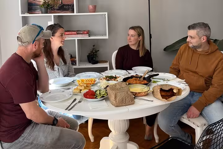 Travelers share an authentic homemade Turkish breakfast with local friends at a cozy dining table