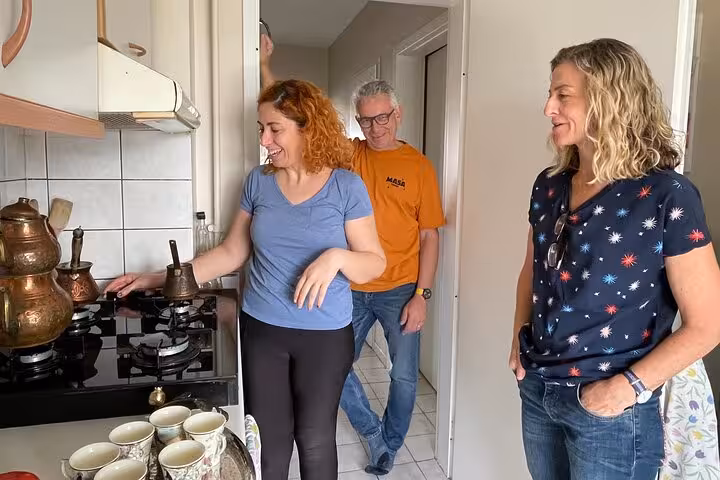 Local host teaches guests at the stove during an authentic Turkish cooking class in a welcoming Istanbul home