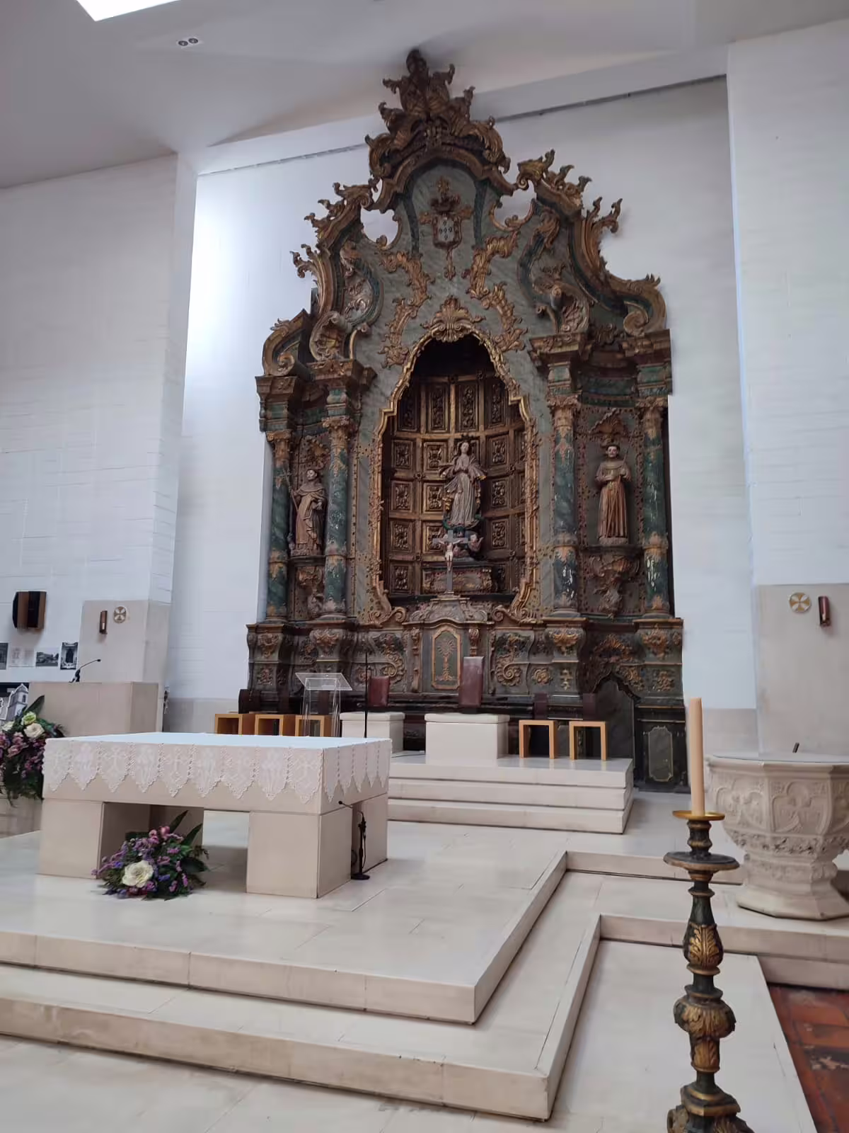 Baroque altar inside Aveiro church, showcasing intricate woodwork and religious sculptures on a half-day city tour.