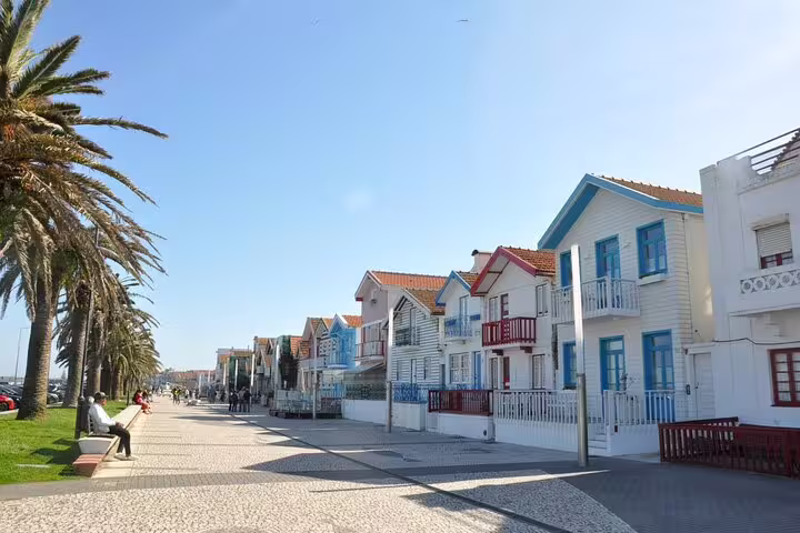 Stroll along Costa Nova's scenic promenade lined with colorful houses on the Aveiro & Costa Nova tour from Porto.