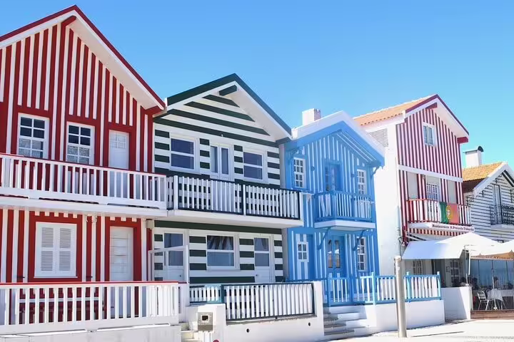 Admire the vibrant striped houses of Costa Nova, a highlight of the Aveiro & Costa Nova private full-day tour from Porto.