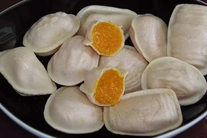 Traditional Portuguese pastries with bright orange filling, showcasing local Aveiro flavors on the small-group tour.