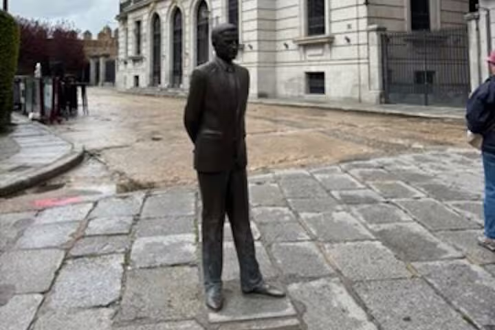 Bronze statue in Avila old town near historic stone streets, stop on half-day private minivan tour from Madrid
