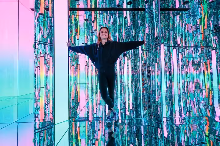 Visitor enjoying vibrant mirrored corridor at Aya Universe Dubai during a private videography tour experience.