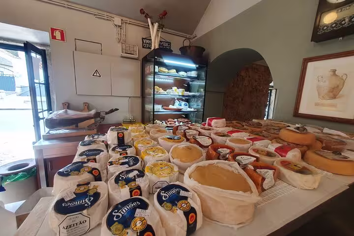 Artisan cheeses displayed in a traditional shop in Azeitão, highlighting local flavors on the Arrábida, Azeitão, Setúbal & Palmela tour.