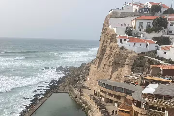 Scenic view of Azenhas do Mar's cliffside houses overlooking the Atlantic Ocean on the Sintra & Cascais tour.
