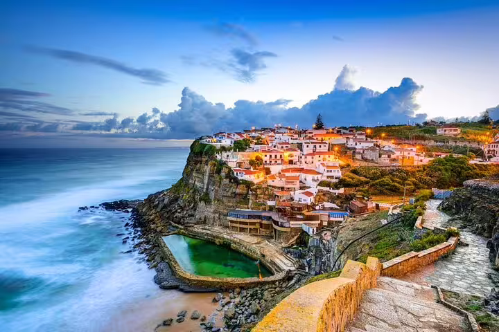 Scenic view of Azenhas do Mar at sunset, showcasing stunning cliffs and ocean on the Sintra and Cascais private wine tour.