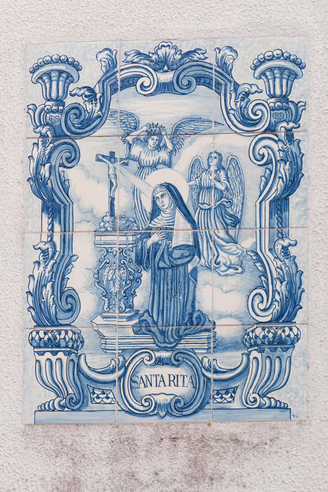 Azulejo tile art depicting Santa Rita, showcasing traditional Portuguese craftsmanship on an Alfama photo walk in Lisbon.