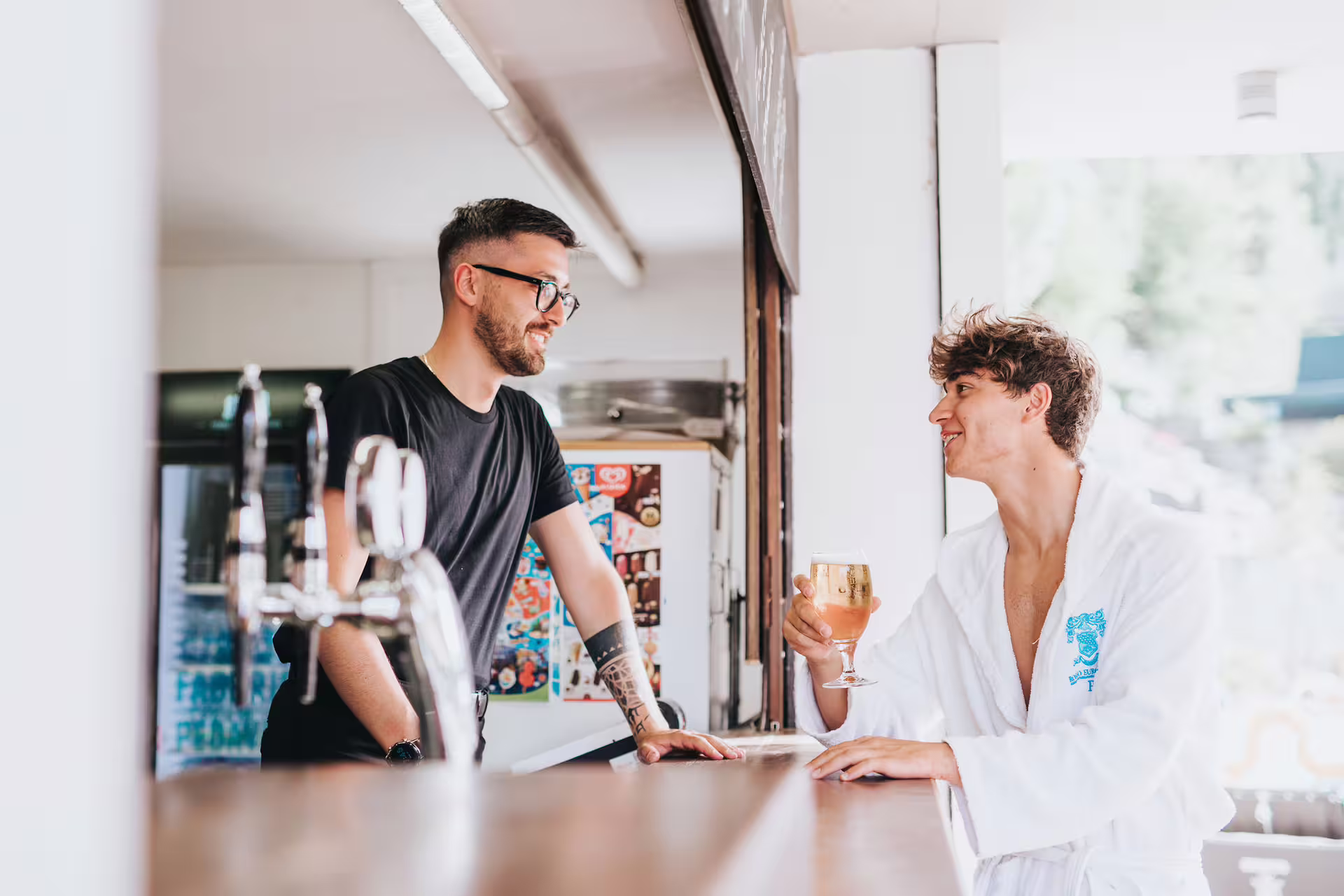 Guest in spa robe enjoying an aperitif at the bar in Bagno di Romagna thermal spa weekend package
