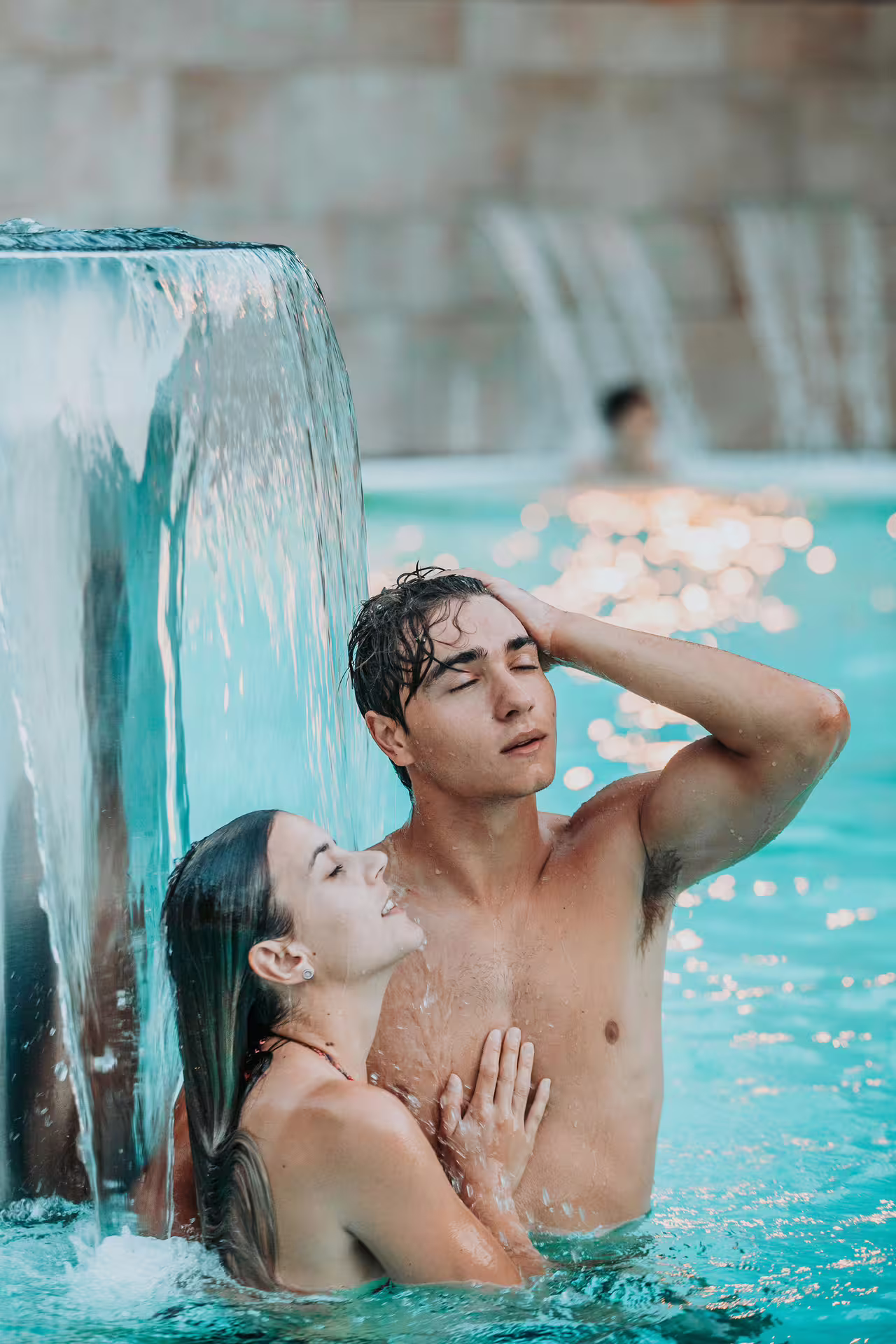 Couple relaxing under waterfall at Bagno di Romagna thermal spa pool, 2-hour entry with aperitif Mon-Wed