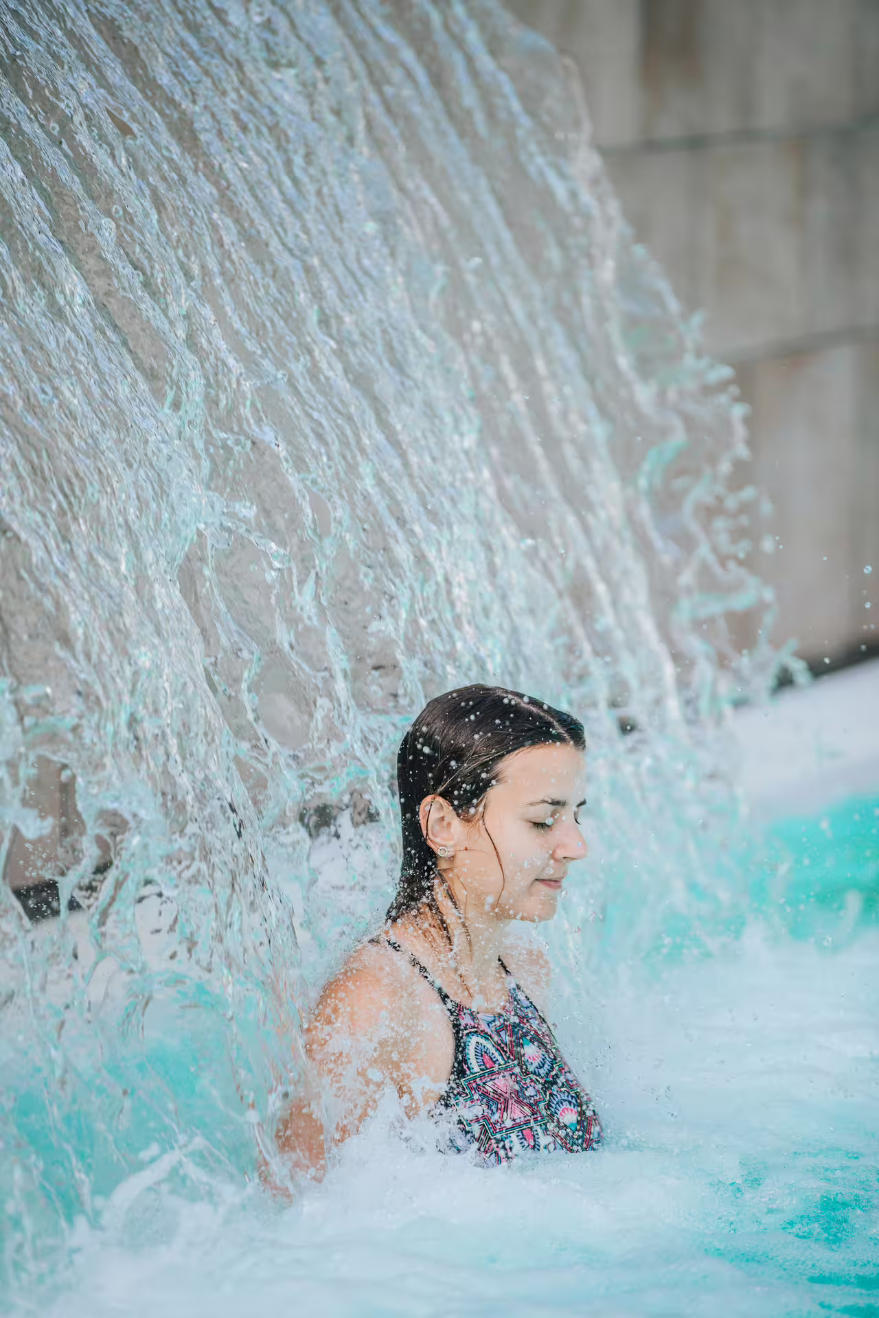 Woman enjoying waterfall massage in Bagno di Romagna thermal pool, 2-hour entry with aperitif weekdays