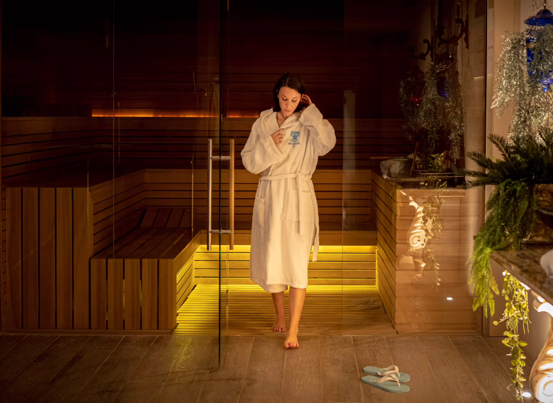 Woman in robe leaving sauna at Bagno di Romagna spa, included in thermal pool entry, lunch and 25 min massage