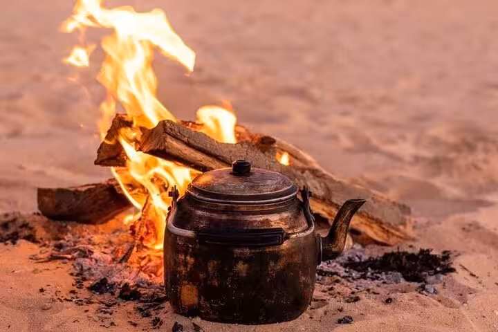 Campfire cooking kettle in the Sahara on a 3-day eco Bahariya Oasis camping tour, Egypt White Desert night