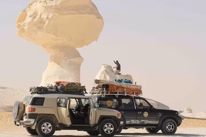 4x4 jeeps at White Desert mushroom rock on 3-day eco Bahariya Oasis camping tour in Egypt