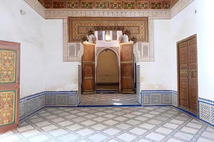 Bahia Palace courtyard with carved cedar doors and zellige tiles in Marrakech on a full-day sightseeing tour with a local