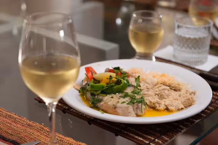 Exquisite Bahian meal served with wine, featuring traditional flavors at a Salvador cooking class.