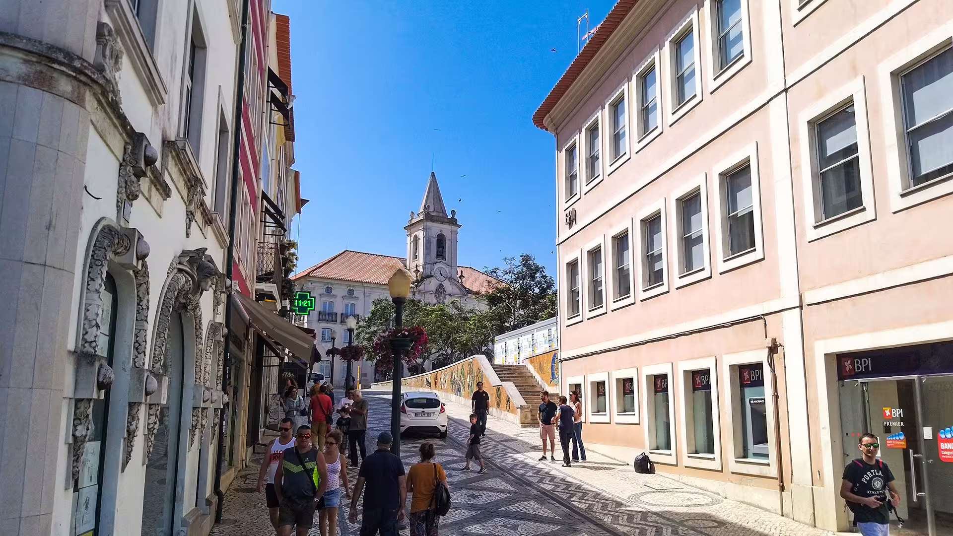 Vibrant street scene in Aveiro with tourists exploring historic architecture, perfect for a Costa Nova striped houses tour.