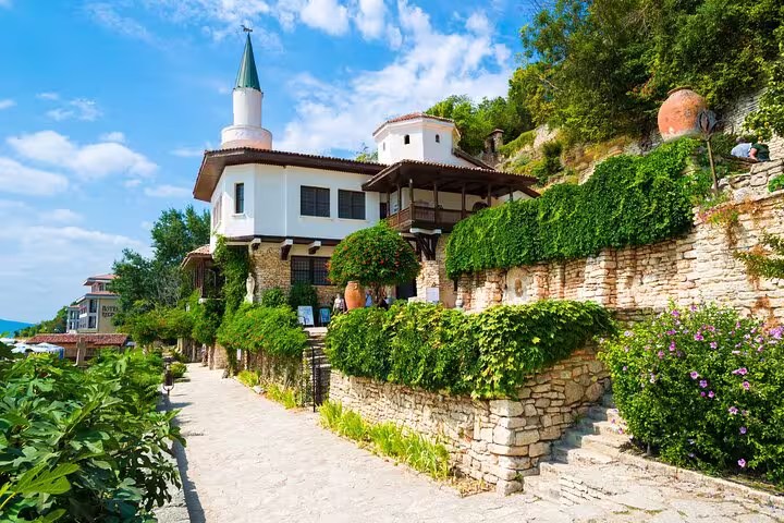 Explore the historic Balchik Palace, a stunning blend of architectural styles surrounded by lush greenery and the Black Sea.