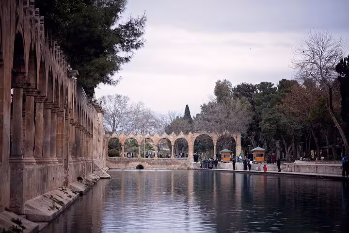 Balikligol Sacred Fish Pool and stone arches in Sanliurfa, Turkey, on an all-inclusive private guided tour